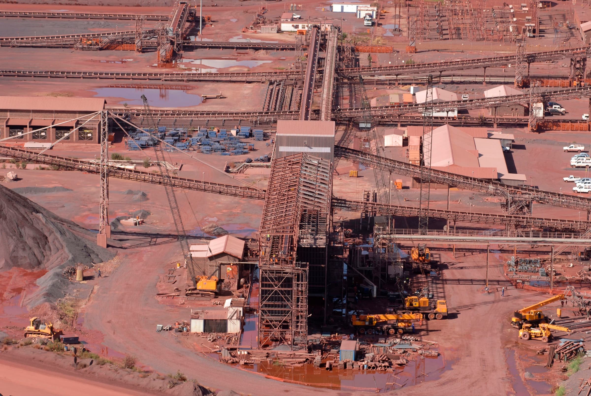 Iron ore mine conveyor network and transfer infrastructure