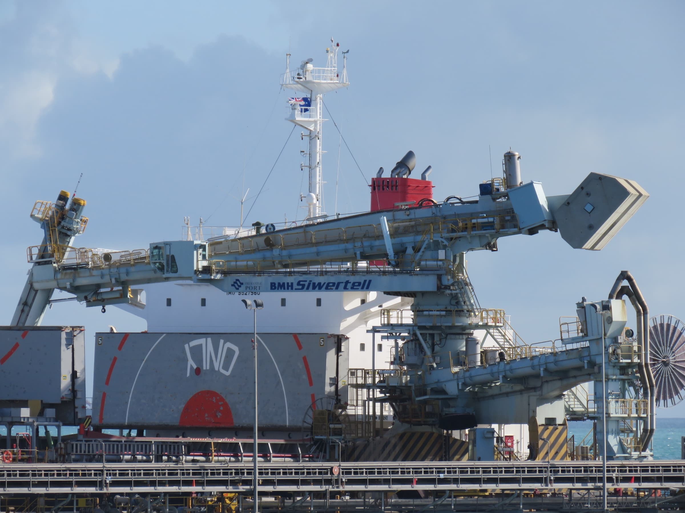 Bulk carrier, ship loader and conveyor infrastructure